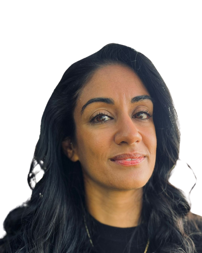 A close up headshot of a South Asian woman with long dark brown hair smiling, wearing black.