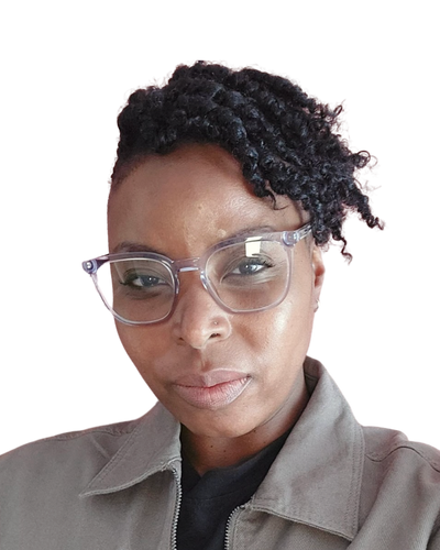 Black woman wearing glasses, with hair twisted to the left hand side. Wearing a grey jacket with black t-shirt.